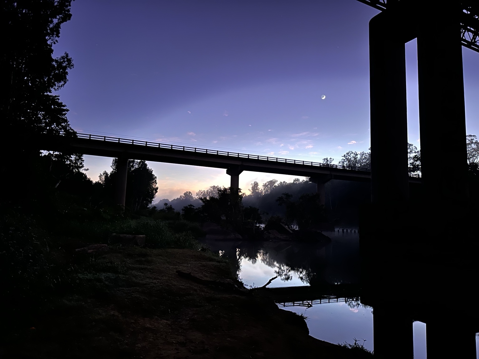 Moon and dawn light above the Pioneer River bridge